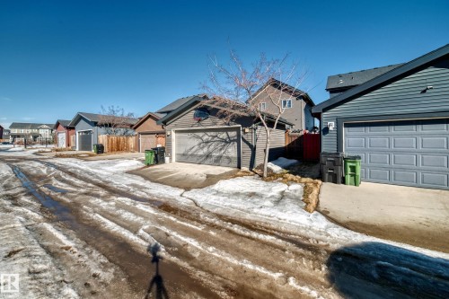 This property includes a detached garage with a gray sectional garage door and gray siding - 8204 224 Nw, Edmonton, AB - Outdoor