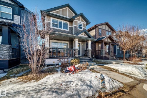 The property features a two-story exterior with multi-toned siding and stone accents - 8204 224 Nw, Edmonton, AB - Outdoor With Deck Patio Veranda With Facade