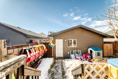 The property features a detached building with siding and a white door, and a partially fenced yard - 8204 224 Nw, Edmonton, AB - Outdoor With Exterior