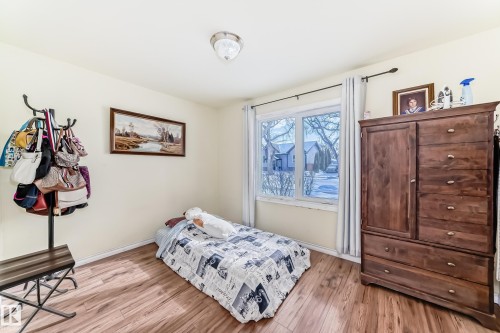 Bedroom with light wood finished floors and baseboards - 3634 113 Avenue, Edmonton, AB - Indoor Photo Showing Bedroom