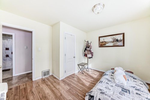 Bedroom with light wood finished floors and baseboards - 3634 113 Avenue, Edmonton, AB - Indoor Photo Showing Bedroom