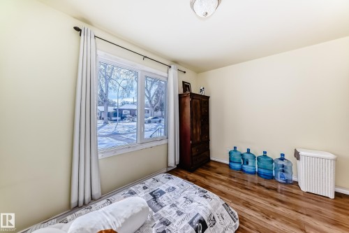 Bedroom featuring dark wood-style flooring and baseboards - 3634 113 Avenue, Edmonton, AB - Indoor Photo Showing Bedroom