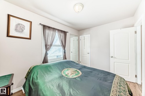 Bedroom with light wood-type flooring and a closet - 3634 113 Avenue, Edmonton, AB - Indoor Photo Showing Bedroom
