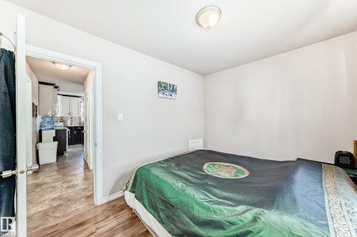 Bedroom featuring baseboards and light wood finished floors - 3634 113 Avenue, Edmonton, AB - Indoor Photo Showing Bedroom