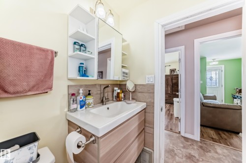 Half bathroom featuring vanity and tasteful backsplash - 3634 113 Avenue, Edmonton, AB - Indoor Photo Showing Bathroom