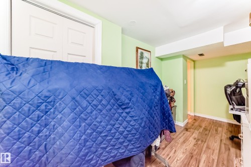 Bedroom featuring wood finished floors and a closet - 3634 113 Avenue, Edmonton, AB - Indoor