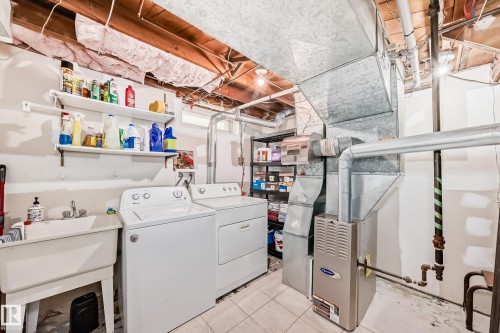 Laundry area with heating unit and washer and clothes dryer - 3634 113 Avenue, Edmonton, AB - Indoor Photo Showing Laundry Room