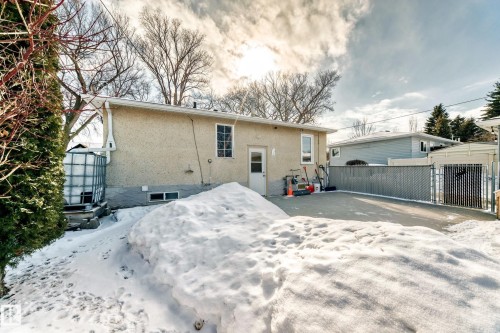 Back of property with stucco siding and a gate - 3634 113 Avenue, Edmonton, AB - Outdoor