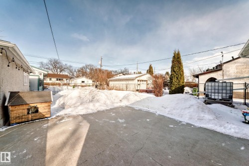 Snowy yard with a residential view and a patio - 3634 113 Avenue, Edmonton, AB - Outdoor