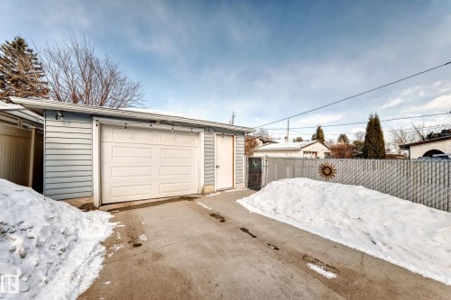 Snow covered garage with a detached garage and concrete driveway - 3634 113 Avenue, Edmonton, AB - Outdoor