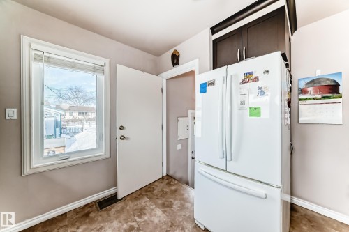 Kitchen with freestanding refrigerator and dark wood finish cabinetry - 3634 113 Avenue, Edmonton, AB - Indoor Photo Showing Other Room