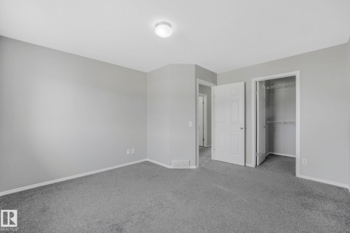 This room features light grey walls, grey carpet flooring, and a flush mount ceiling light fixture - 123 230 Edwards Drive, Edmonton, AB - Indoor Photo Showing Other Room
