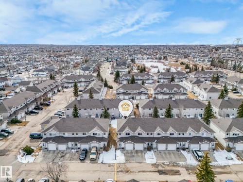 Aerial view of the property, showcasing the surrounding residential area and a nearby body of water - 123 230 Edwards Drive, Edmonton, AB - Outdoor With View
