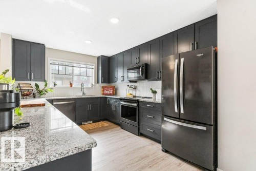 102 3305 Orchards Link Link, Edmonton, AB - Indoor Photo Showing Kitchen With Stainless Steel Kitchen With Double Sink With Upgraded Kitchen