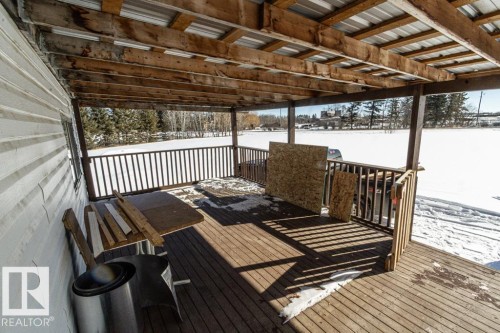 Covered outdoor deck with exposed wood beams and a metal roof - 112, 57004 Range Rd 105, Rural St. Paul County, AB -  With Exterior
