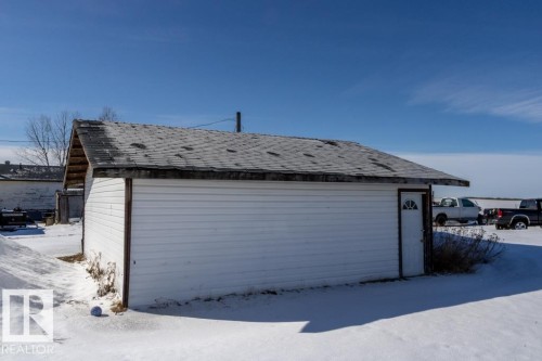 The property includes a white detached structure with a door featuring an arched window - 112, 57004 Range Rd 105, Rural St. Paul County, AB - Outdoor