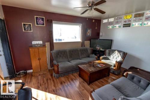 The living area features hardwood floors and a ceiling fan with integrated lighting - 112, 57004 Range Rd 105, Rural St. Paul County, AB - Indoor Photo Showing Living Room
