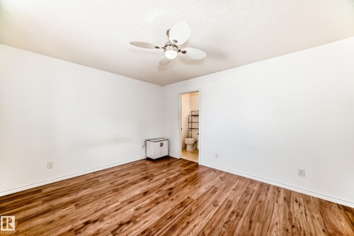 This room features rich wood-look flooring and a ceiling fan with integrated lighting - 1832 42 Street, Edmonton, AB - Indoor Photo Showing Other Room
