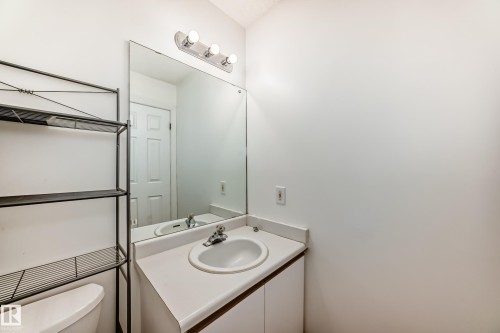Bathroom vanity with an integrated sink and a large wall-mounted mirror - 1832 42 Street, Edmonton, AB - Indoor Photo Showing Bathroom