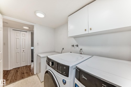 Laundry area featuring white walls, overhead cabinetry, and recessed lighting - 1832 42 Street, Edmonton, AB - Indoor Photo Showing Laundry Room