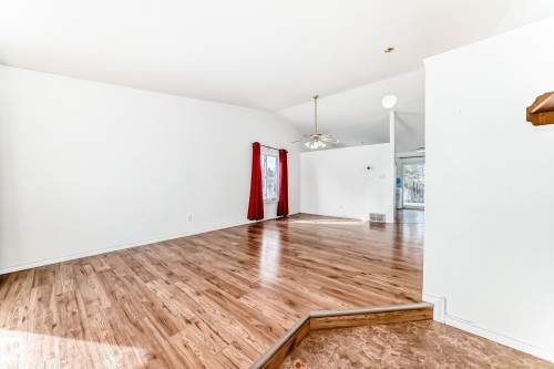 Open concept living area featuring hardwood flooring and vaulted ceilings - 1832 42 Street, Edmonton, AB - Indoor Photo Showing Other Room
