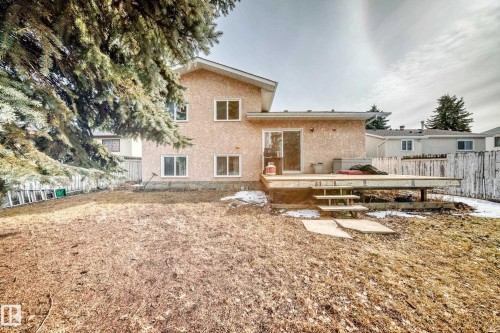 The property features a rear deck with steps leading to the yard, and a sliding glass door providing access to the interior - 1832 42 Street, Edmonton, AB - Outdoor