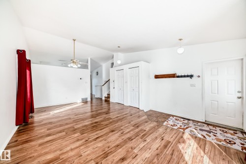The property features wood-look flooring throughout the main living area - 1832 42 Street, Edmonton, AB - Indoor Photo Showing Other Room