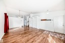 The property features wood-look flooring throughout the main living area - 1832 42 Street, Edmonton, AB  - Indoor Photo Showing Other Room 