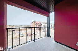 A private balcony with a dark red exterior wall and black railings - 