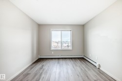 This room features light-colored walls and a window with a white frame - 