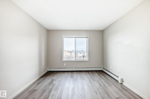 This room features light-colored walls and a window with a white frame - 332 344 Windermere Road, Edmonton, AB - Indoor Photo Showing Other Room