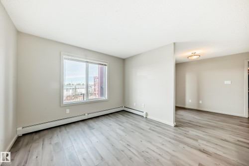 The property features light-colored walls and wood-style flooring throughout - 332 344 Windermere Road, Edmonton, AB - Indoor Photo Showing Other Room