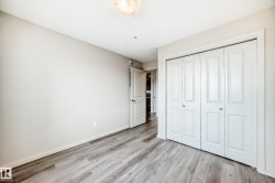 This room features light-colored walls and modern wood-look flooring - 