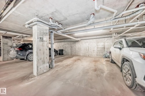 Dedicated indoor parking space with concrete flooring and walls - 332 344 Windermere Road, Edmonton, AB - Indoor Photo Showing Garage