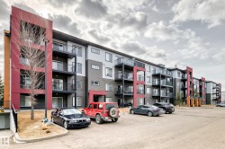 The property features a multi-story building with a modern facade, incorporating grey, red, and orange exterior panels - 