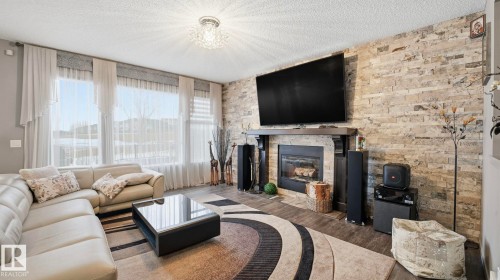 1027 Coopers Hawk Link Link, Edmonton, AB - Indoor Photo Showing Living Room With Fireplace
