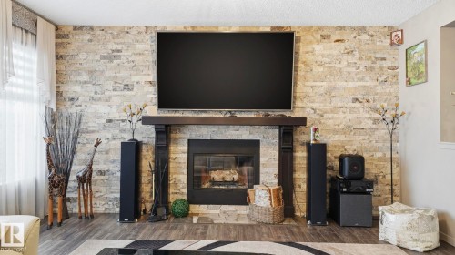 1027 Coopers Hawk Link Link, Edmonton, AB - Indoor Photo Showing Living Room With Fireplace