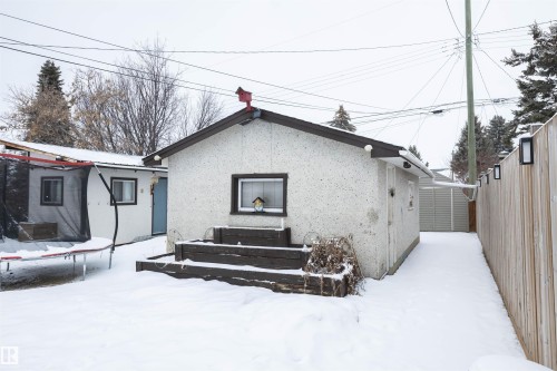 The property includes a detached structure with a pitched roof, a window, and a small wooden deck - 4420 56 Avenue, Barrhead, AB - Outdoor