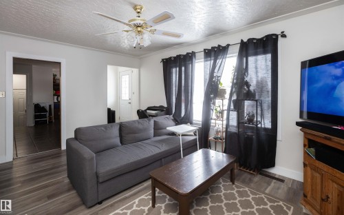 Living area featuring wood-look flooring and a ceiling fan - 4420 56 Avenue, Barrhead, AB - Indoor Photo Showing Living Room