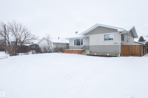 The property features a neutral-toned exterior with stucco and siding finishes - 4420 56 Avenue, Barrhead, AB - Outdoor