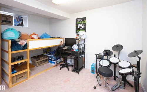 This room features light-colored walls and carpet, with a window providing natural light - 4420 56 Avenue, Barrhead, AB - Indoor