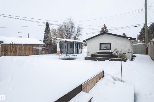 The property features a spacious backyard with a deck and a separate storage shed - 4420 56 Avenue, Barrhead, AB - Outdoor