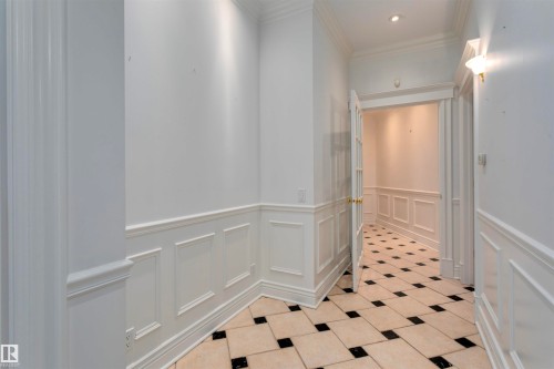 Hallway featuring wainscoting, crown molding, recessed lighting, and checkered tile flooring - 102 11826 100, Edmonton, AB - Indoor Photo Showing Other Room