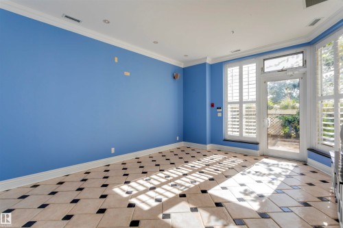This room features tiled flooring with a unique pattern, crown molding, and recessed lighting - 102 11826 100, Edmonton, AB - Indoor Photo Showing Bedroom