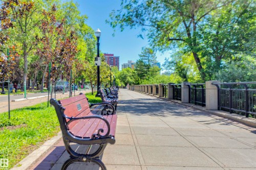 This property offers access to a paved walkway lined with benches and mature trees - 102 11826 100, Edmonton, AB - Outdoor