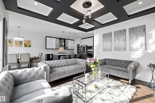 This inviting living area features hardwood floors, a striking coffered ceiling, and recessed lighting - 6303 169 Avenue, Edmonton, AB - Indoor Photo Showing Living Room