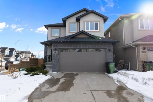 The property features a two-story exterior with a contrasting facade, an attached garage, and a concrete driveway - 6303 169 Avenue, Edmonton, AB - Outdoor