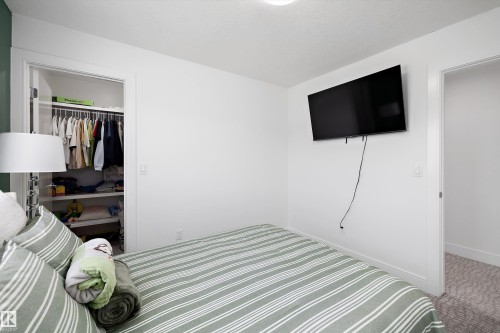 This room features a closet with shelving and a hanging rod, white walls, and a recessed ceiling light - 6303 169 Avenue, Edmonton, AB - Indoor Photo Showing Bedroom
