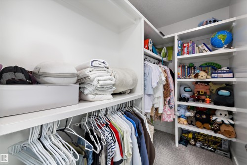 The property features a spacious closet with built-in shelving and hanging rods - 6303 169 Avenue, Edmonton, AB - Indoor With Storage