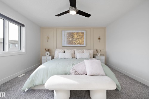 This room features neutral-toned walls, a modern ceiling fan with lighting, and a large window providing natural light - 6303 169 Avenue, Edmonton, AB - Indoor Photo Showing Bedroom